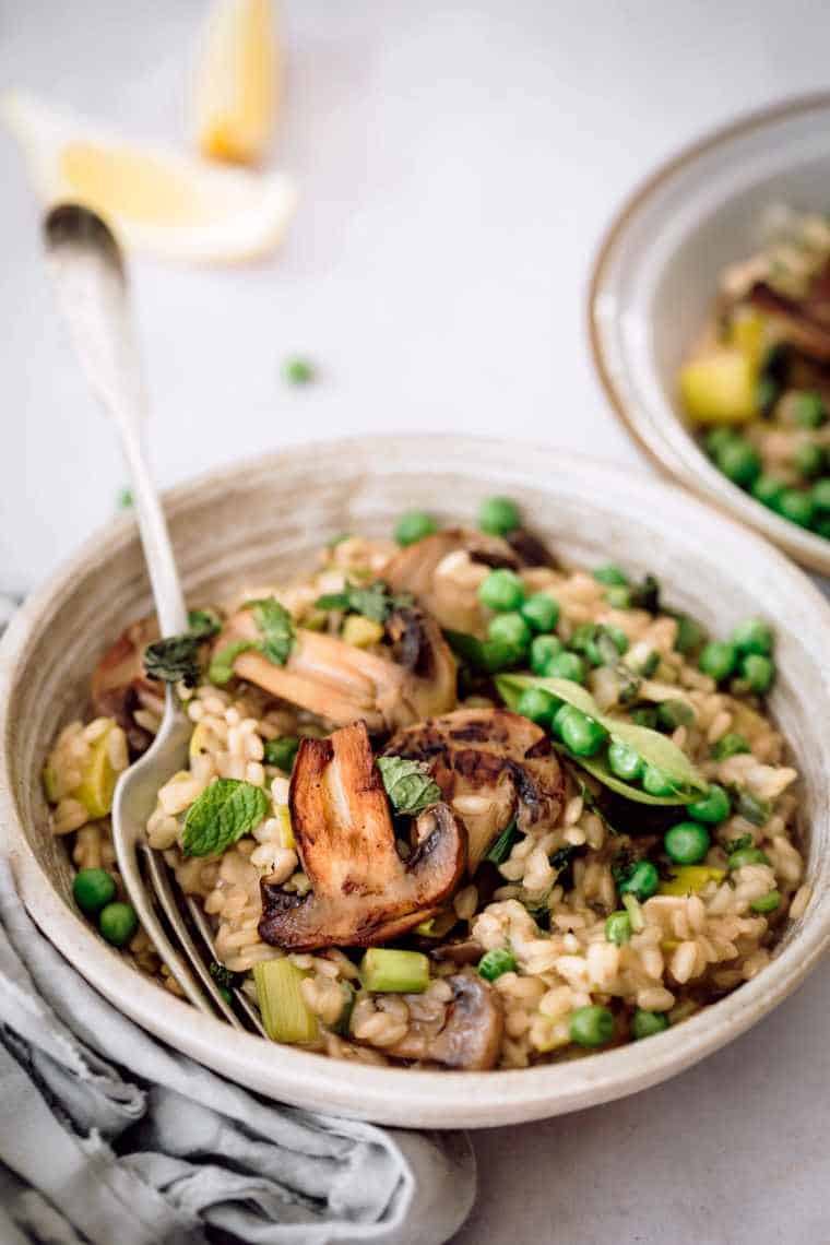 Vegan mushroom risotto in two bowls.