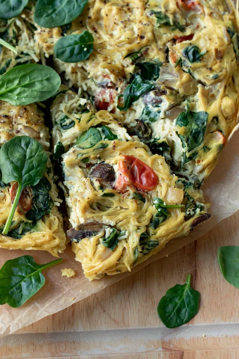 Vegan pasta frittata with a triangle cut.
