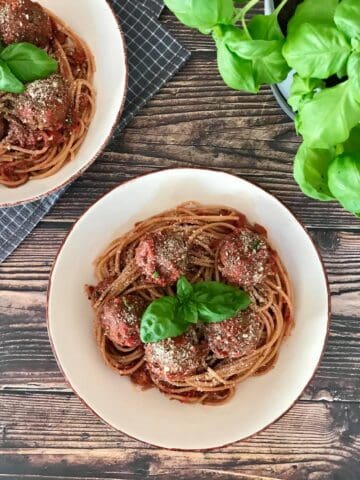 Vegan spaghetti and meatballs in two bowls.
