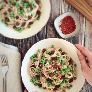 Two bowls of vegan spaghetti carbonara.