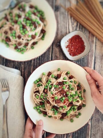 Two bowls of vegan spaghetti carbonara.