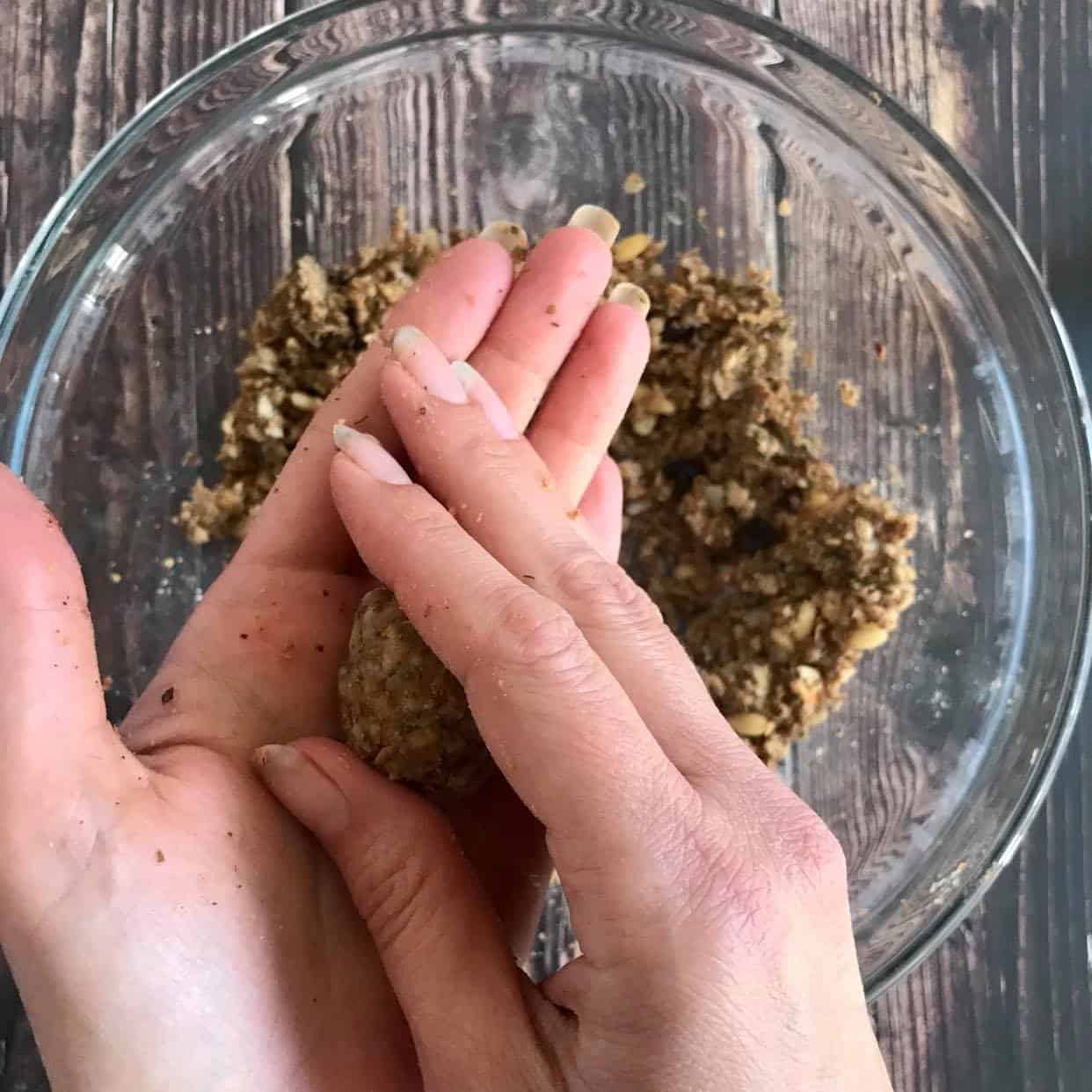 Hands rolling the mixture into a ball.