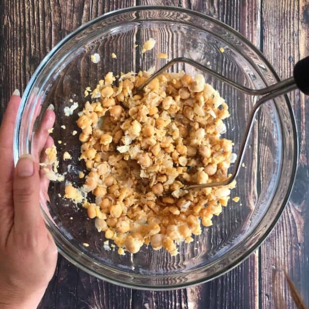 Smashed chickpeas in bowl.