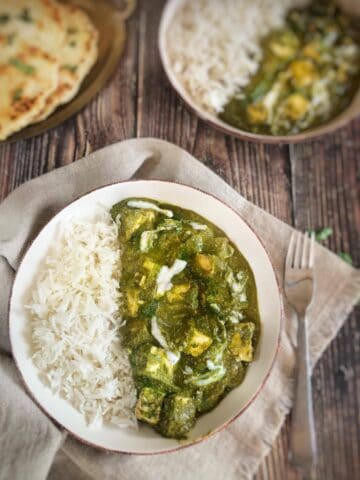 Bowl of vegan palak paneer and rice.