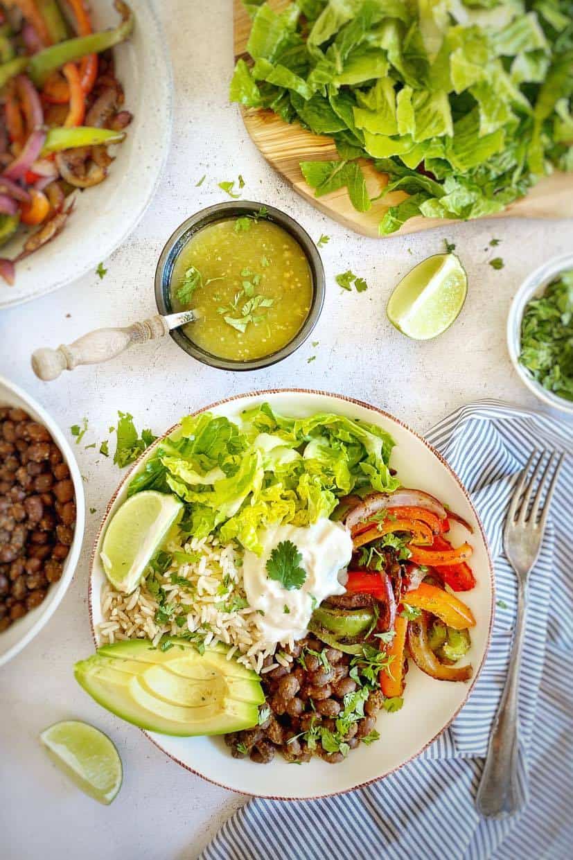 Vegan burrito bowl next to a salsa dish.