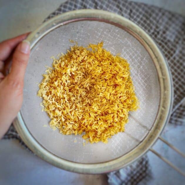 Brown rice in a colander.