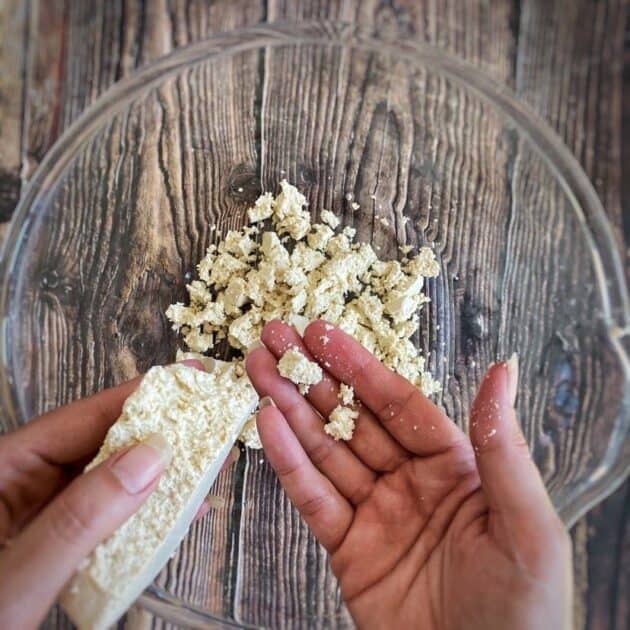 Hand crumbling tofu.