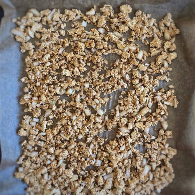 Crumbled tofu on a baking sheet.