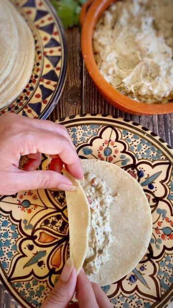 Hand rolling vegan taquito.
