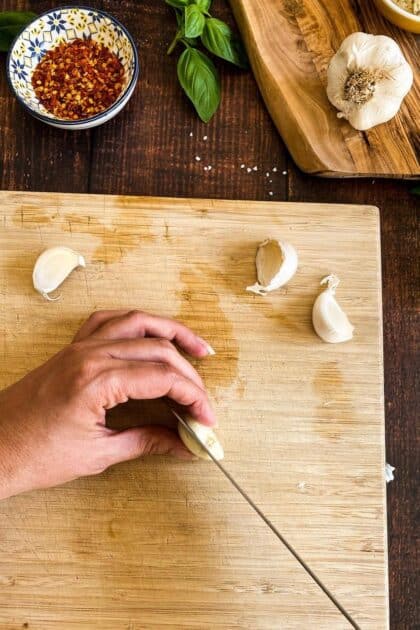 Hand cutting garlic.