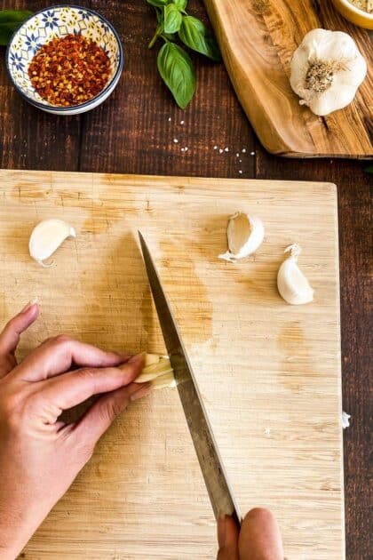 Hand cutting garlic.