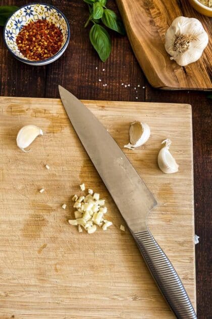 Chopped garlic on a cutting board.