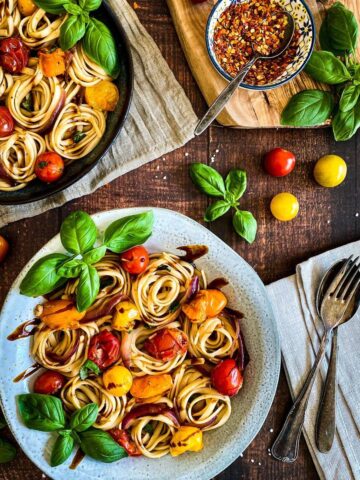 Two bowls of cherry tomato basil pasta.