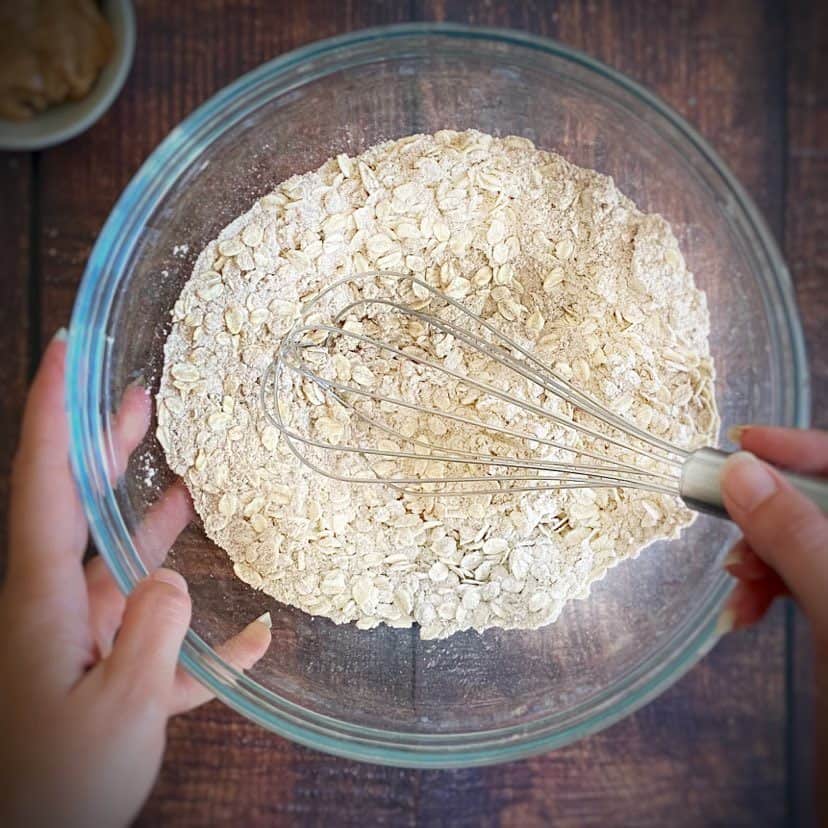 Bowl with dry ingredients for vegan oatmeal cookies.