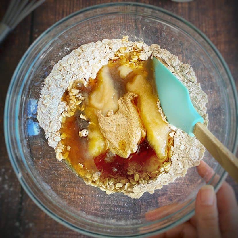 Bowl with wet ingredients added to oatmeal cookie batter.