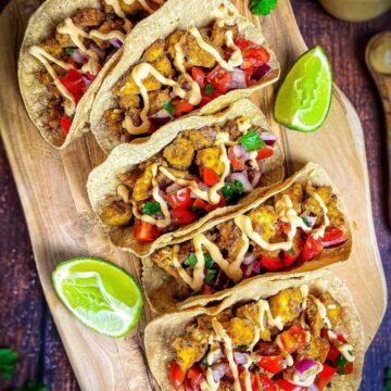Vegan tofu tacos on a cutting board.