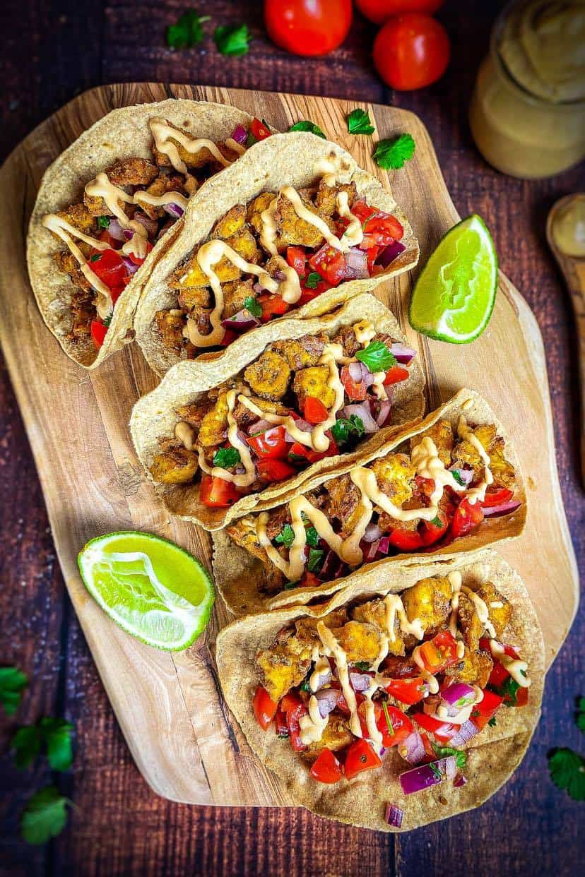 Vegan tofu tacos on a cutting board.