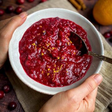 Vegan cranberry sauce in a bowl with a spoon.