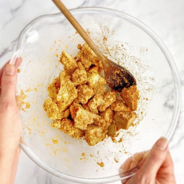 Tofu chunks mixed with paste in a bowl.