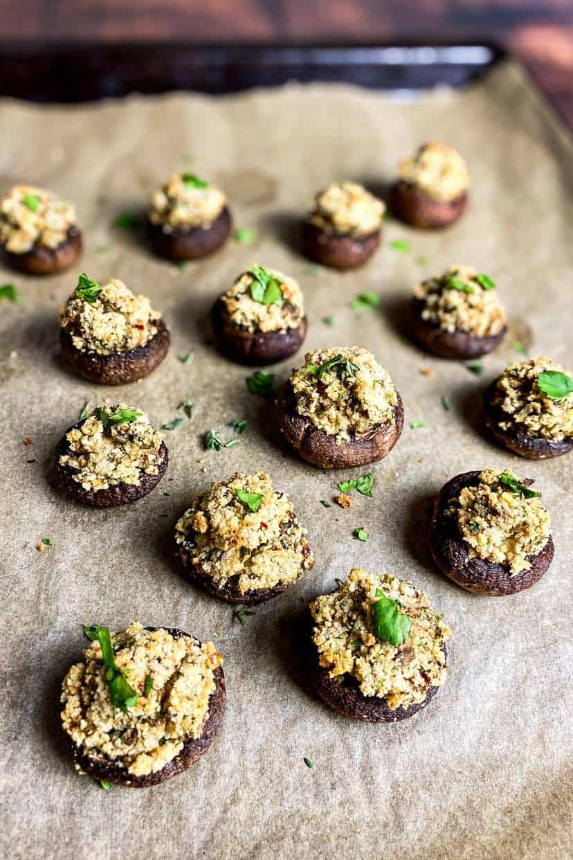Vegan stuffed mushrooms on a baking sheet.