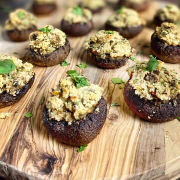 Vegan stuffed mushrooms on a cutting board.