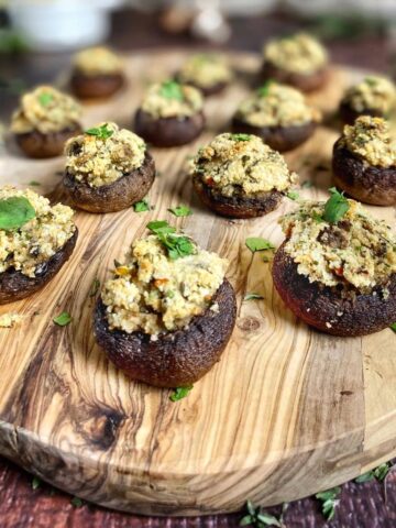 Vegan stuffed mushrooms on a cutting board.