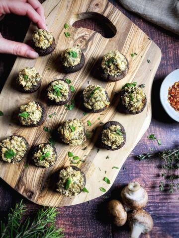 Vegan stuffed mushrooms on a cutting board.