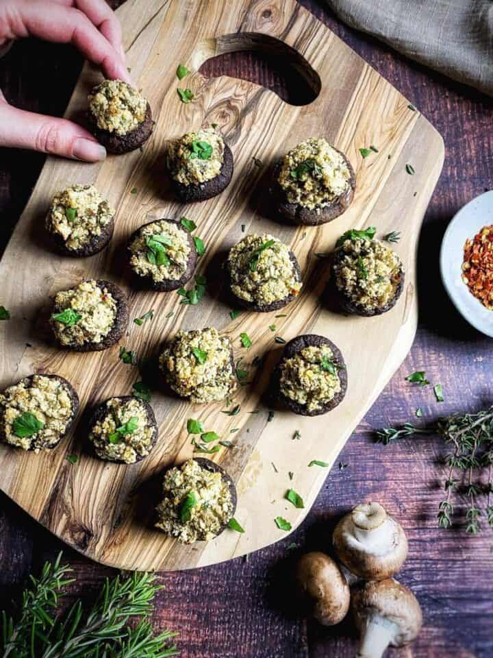 Vegan stuffed mushrooms on a cutting board.