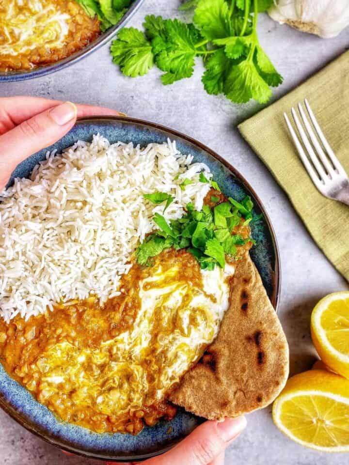 Red lentil dahl in a bowl with rice.
