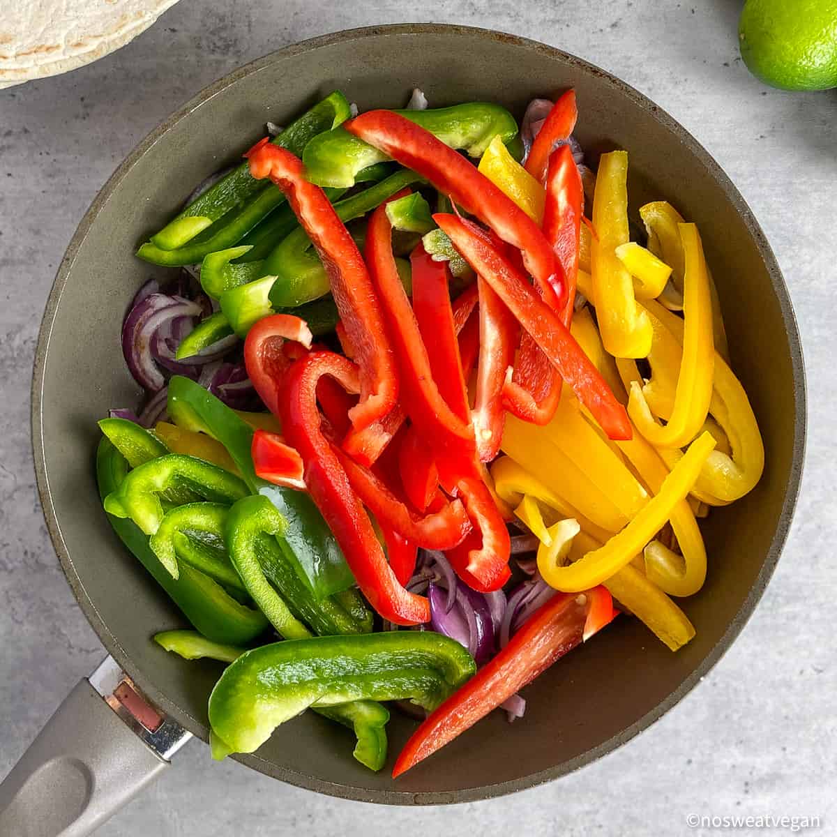 Bell peppers in a skillet.