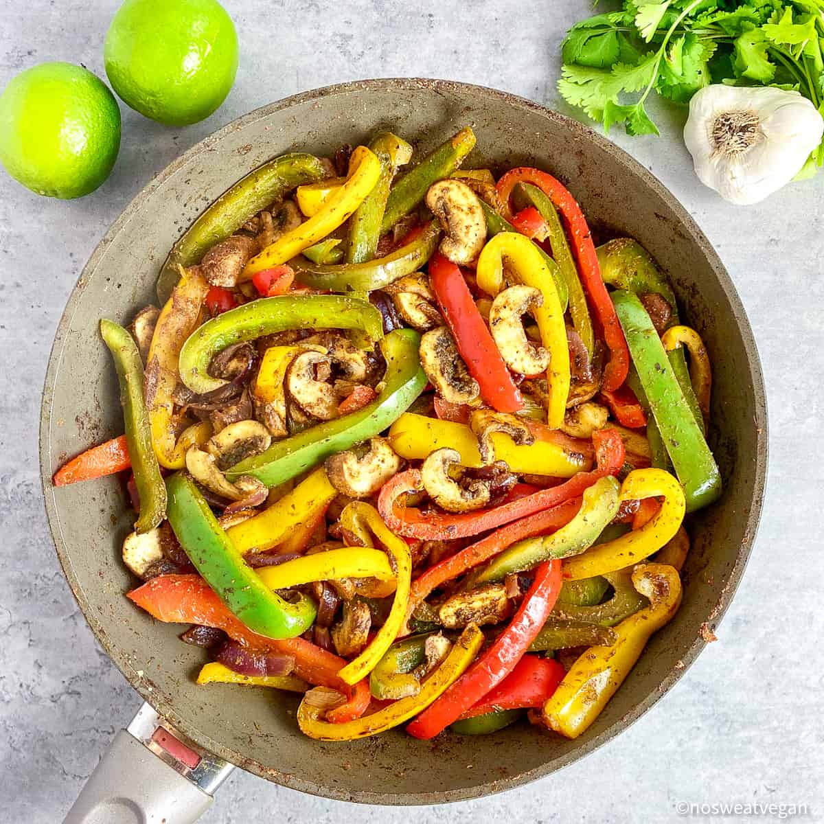 Vegan fajitas cooked in a skillet.