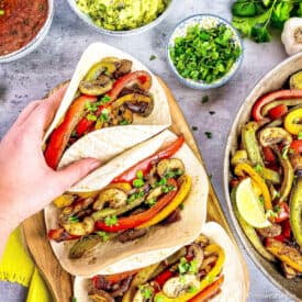 Hand picking up a vegan fajita.