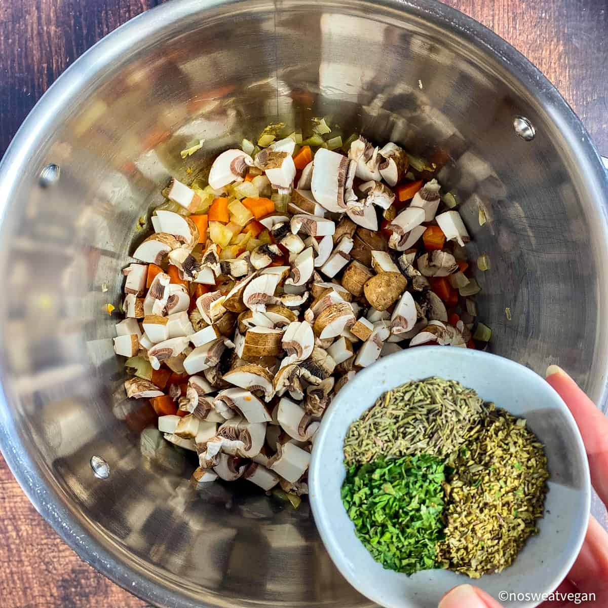 Add mushrooms and herbs to the pot.