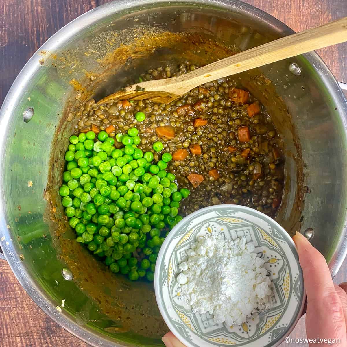 Peas and cornstarch added to the pot.