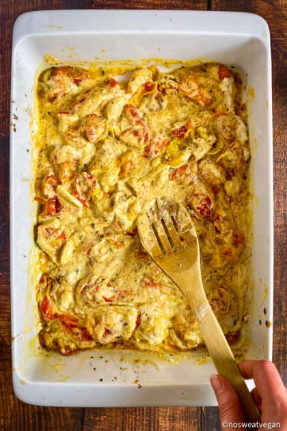 Tomatoes and vegan ricotta mixed in a dish.