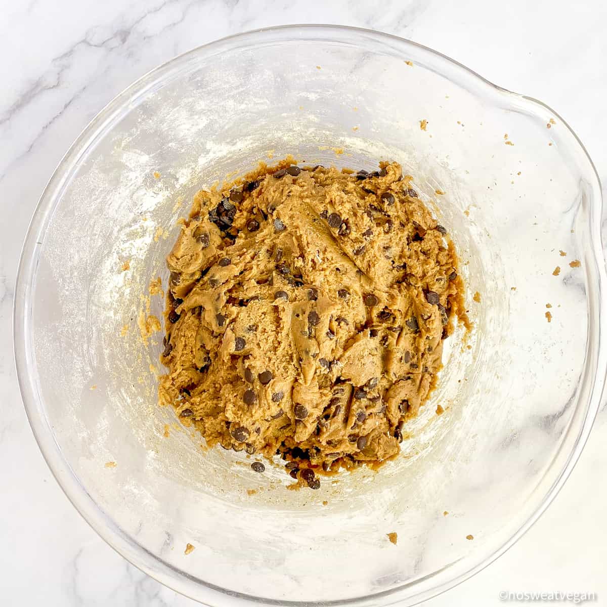 The chocolate chips should be fully incorporated into the cookie dough.