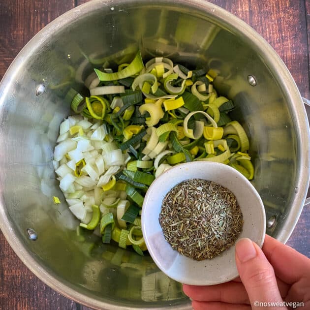 Add the leeks, onions, and spices to a pot.