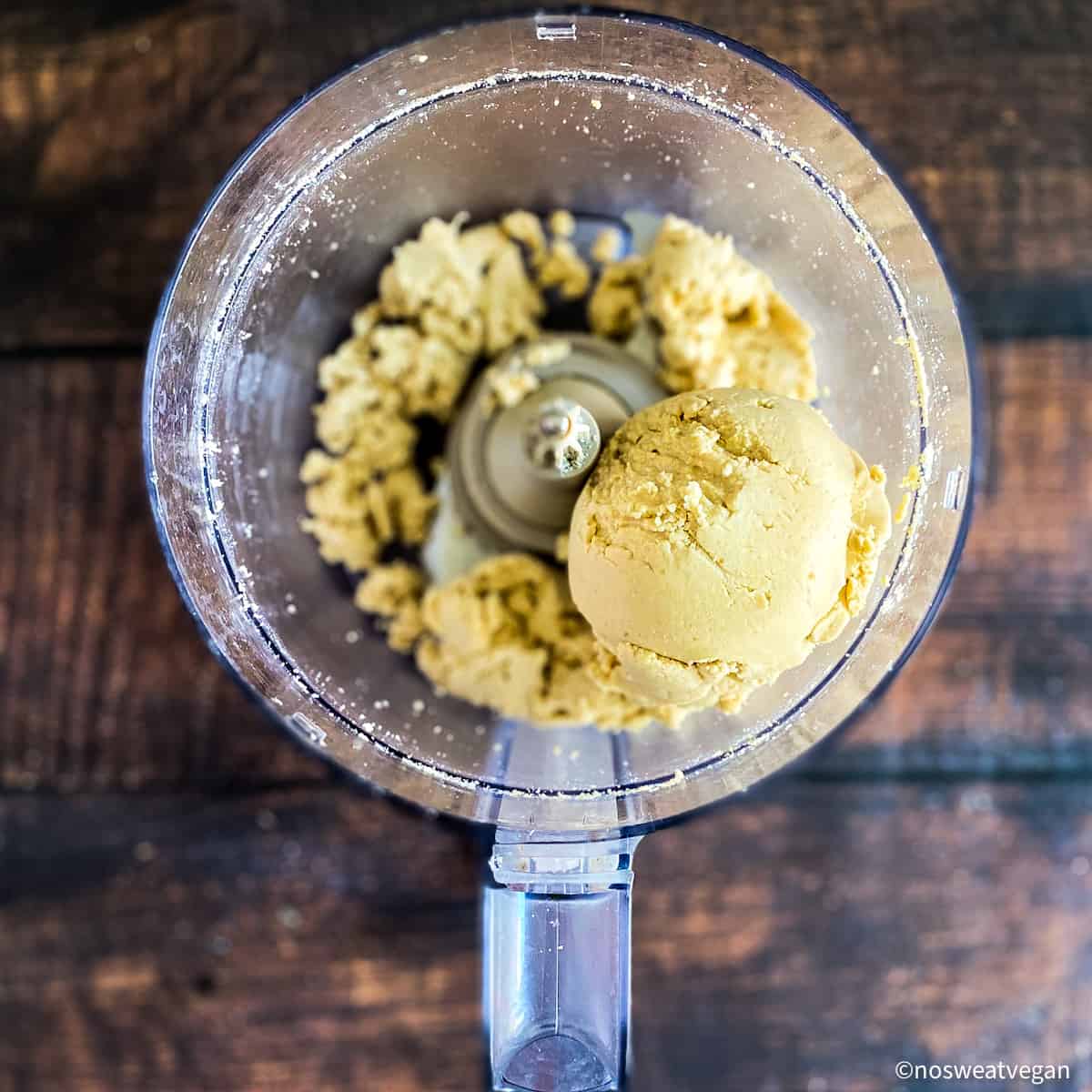 The cashew butter forms a dough-like ball..