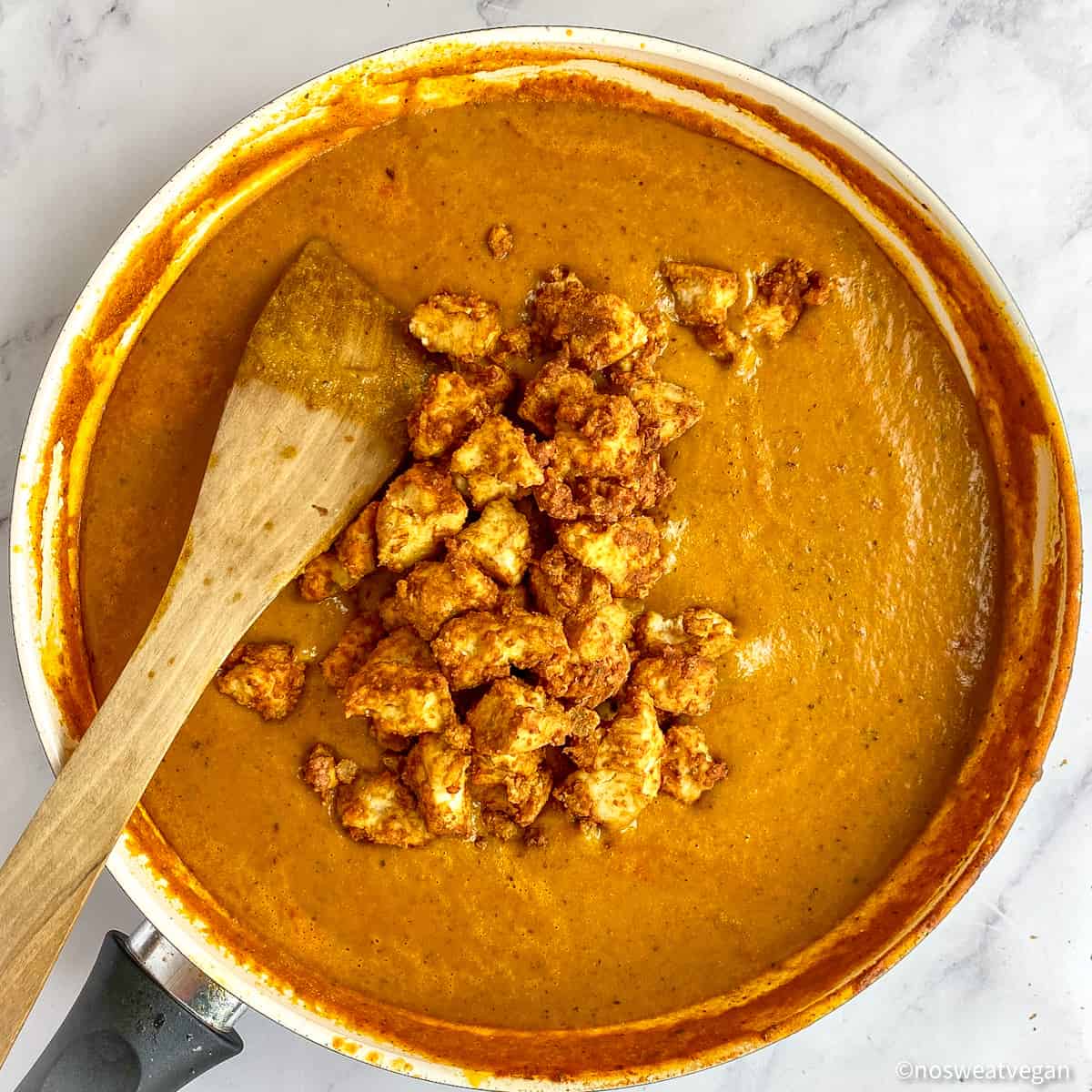 Vegan butter chicken sauce with tandoori tofu sitting on top.
