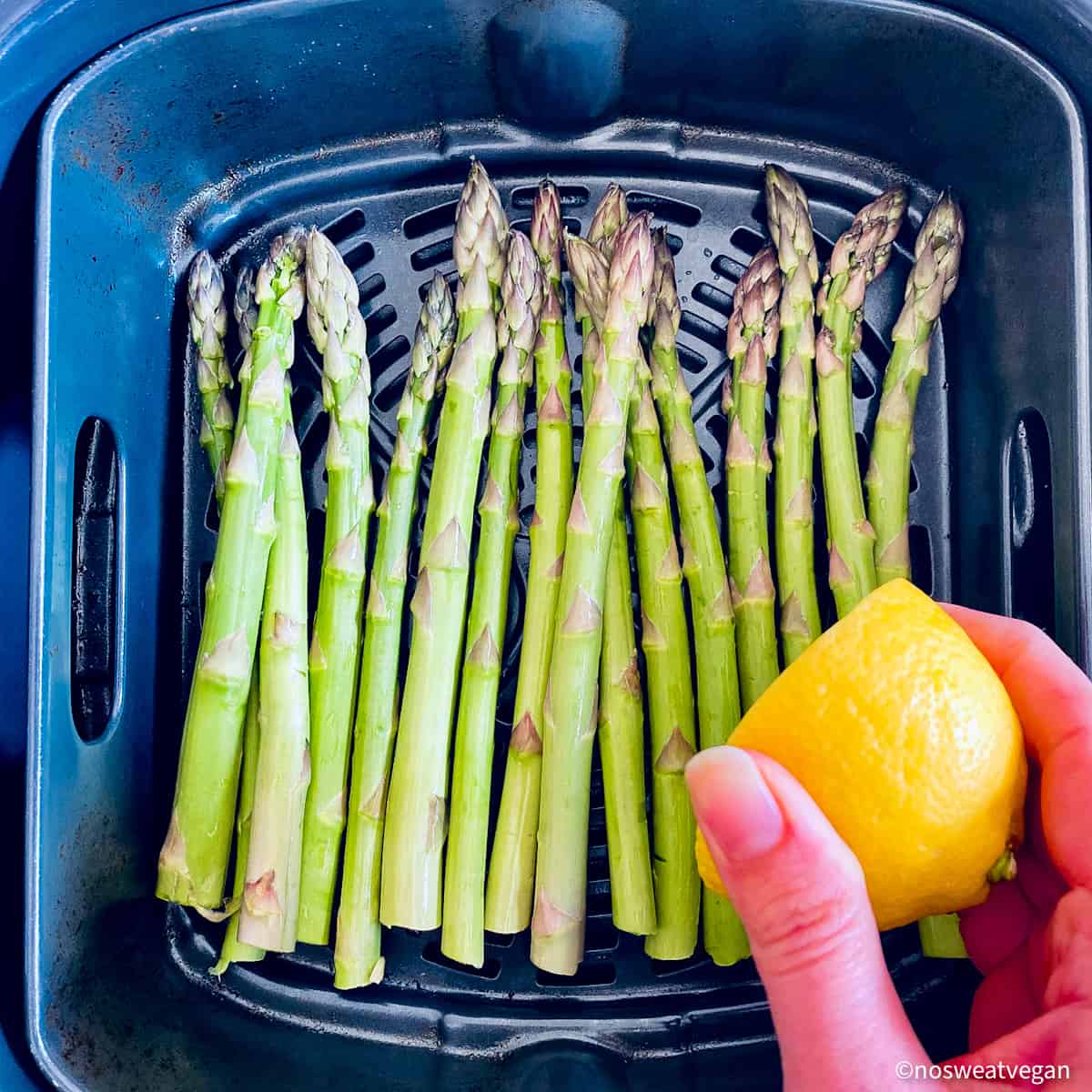 Asparagus in air fryer with lemon juice.