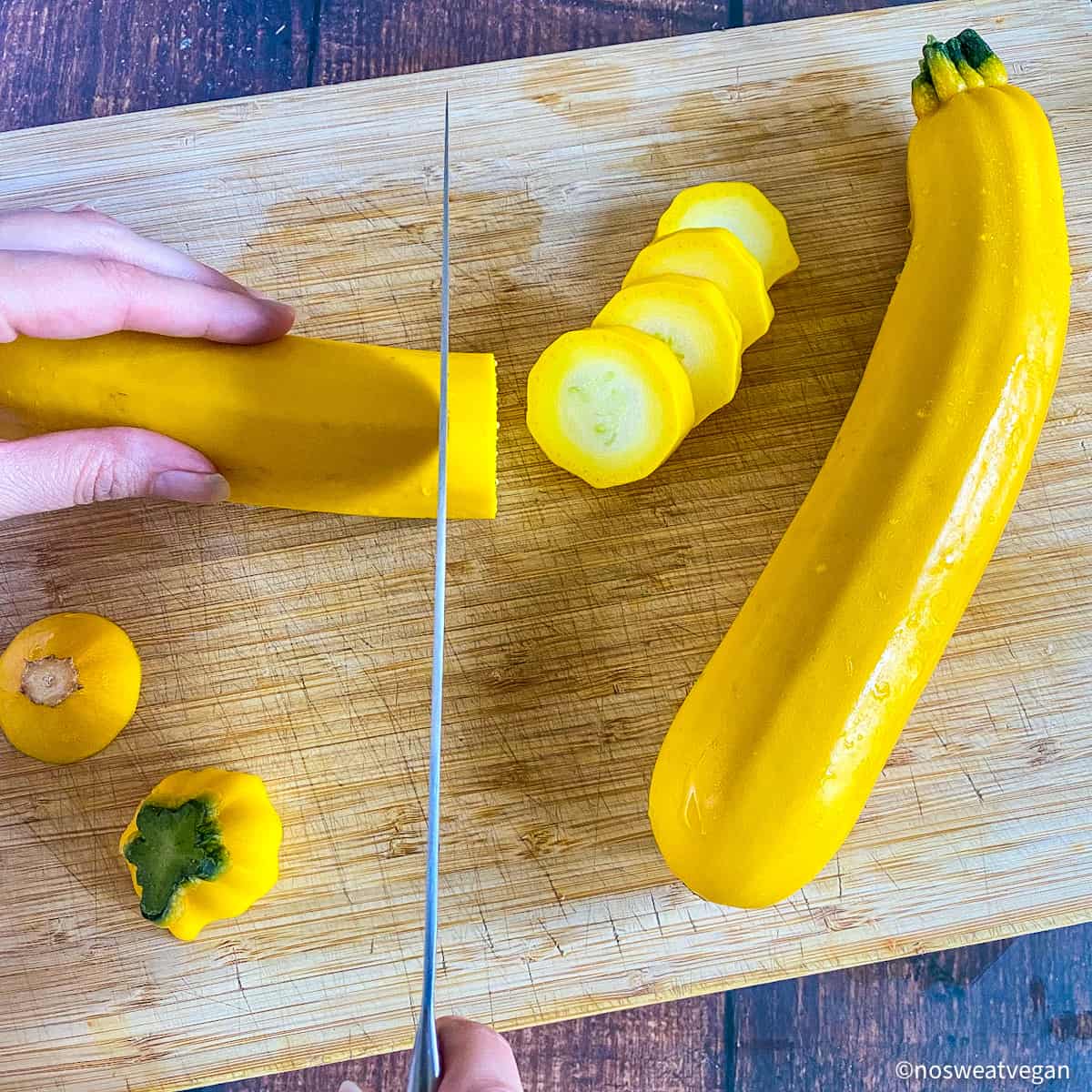 Hand chopping summer squash.
