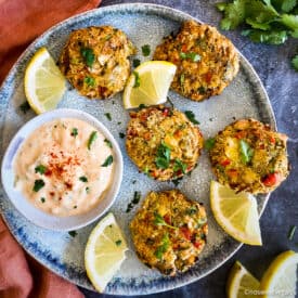 Vegan crab cakes on plate with remoulade sauce.