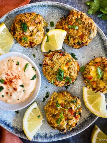 Vegan crab cakes on plate with remoulade sauce.