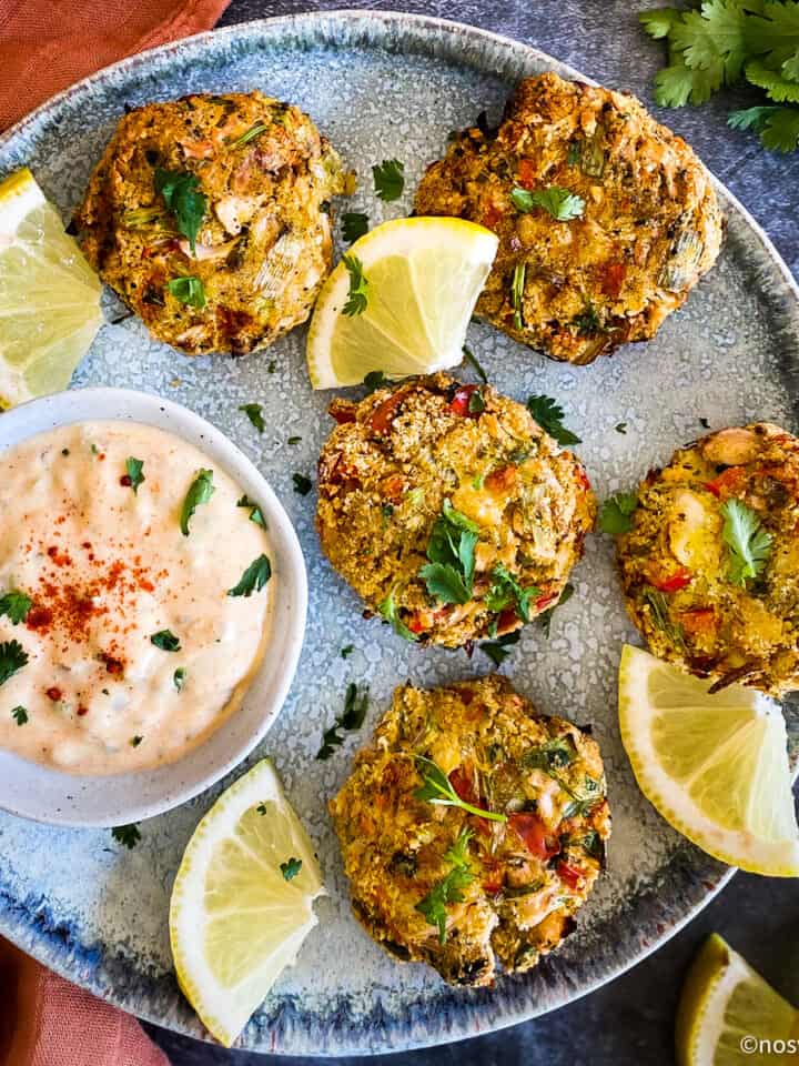 Vegan crab cakes on plate with remoulade sauce.