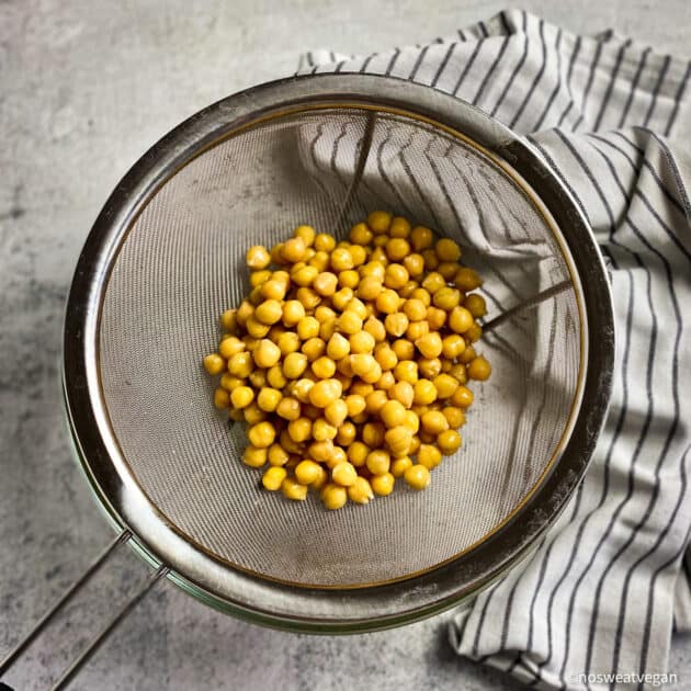 Drained and rinsed chickpeas in a colander.