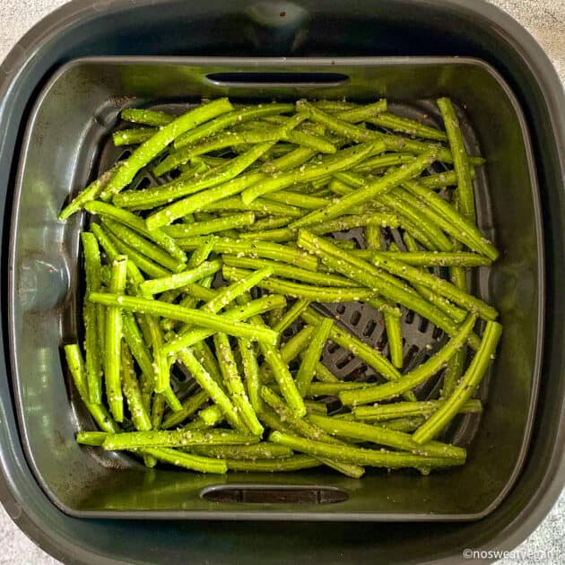 Fresh, seasoned green beans in the air fryer.