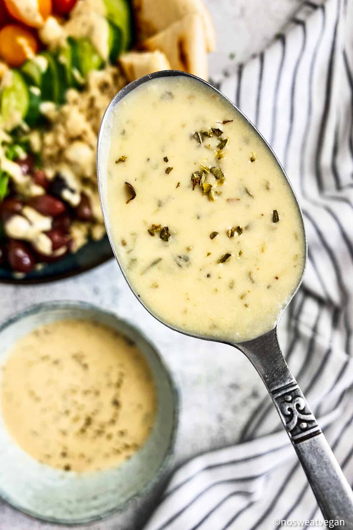 Hummus dressing on spoon close up.