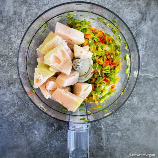 Jackfruit added to vegetables in food processor.