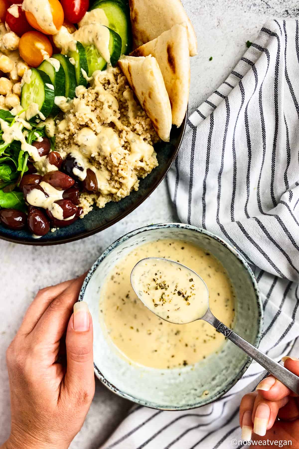 Oil free Greek dressing in bowl next to salad.