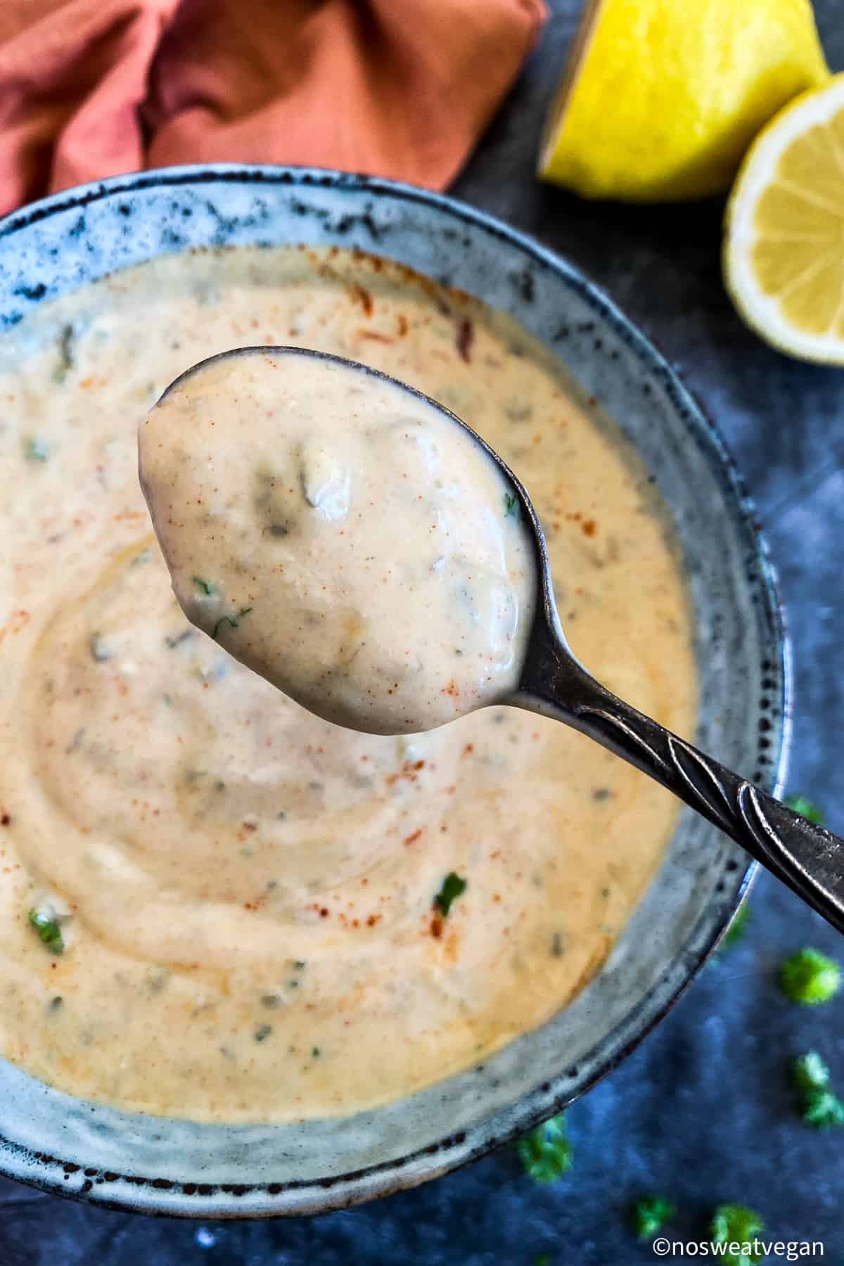 Close up of vegan crab cake sauce on a spoon.